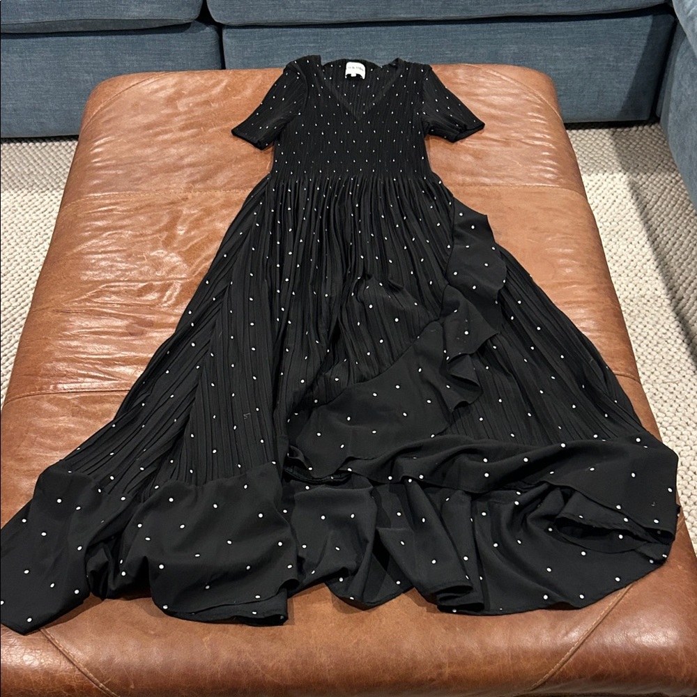 Leo & Ugo Paris black pleated midi dress with white polka dots.